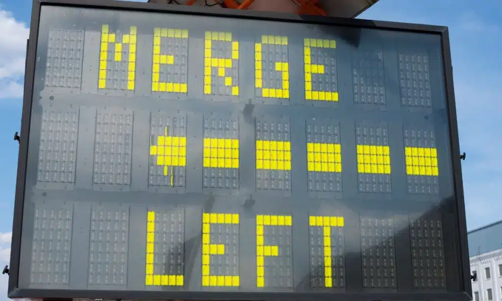 Traffic sign telling vehicles to merge to the left